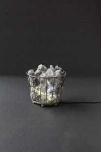 Small black metal basket Himalayan rock salt lamp with natural salt chunks and electric light
